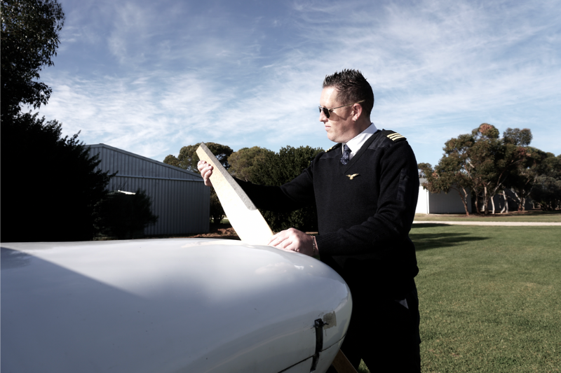 Captain Inspecting Plane Porpeller