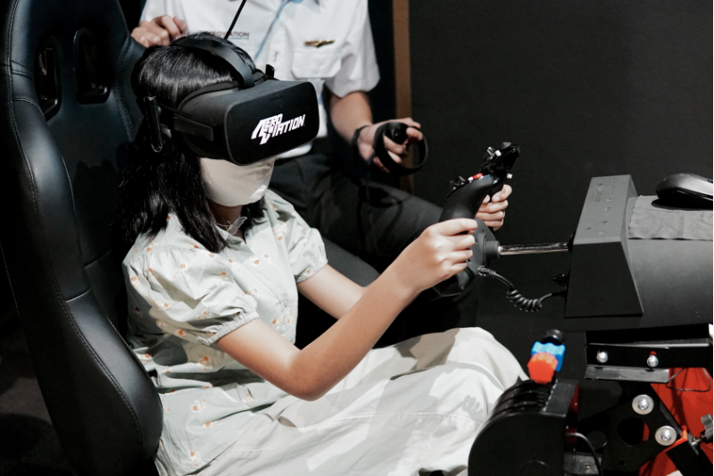 young girl experiencing flight simulator in singapore