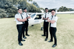 group photo of pilot students and plane