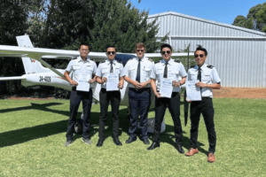 photo of captain and students with their private pilots license