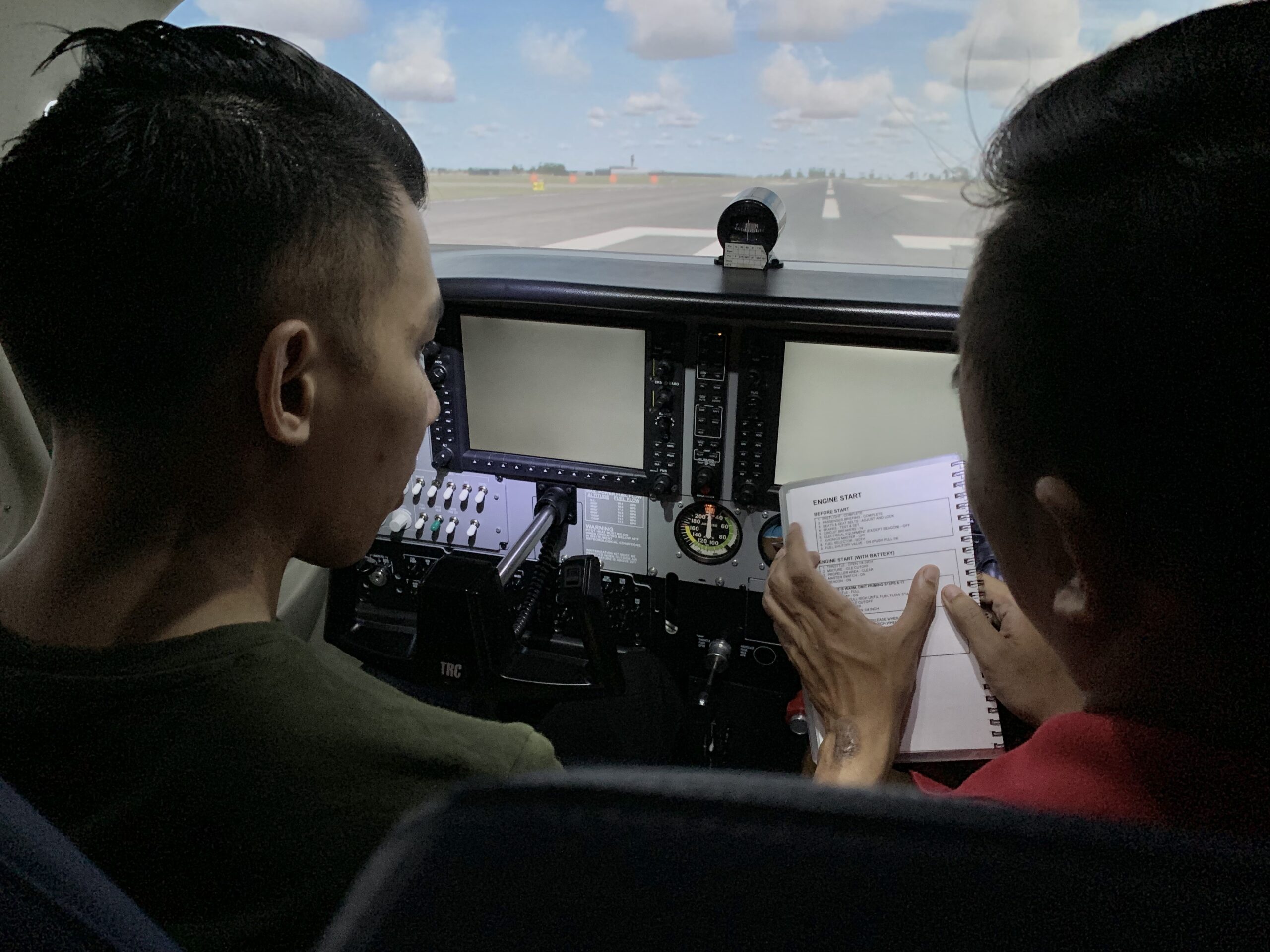 Student pilot learning with instructor in a flight simulator during RPC training in Australia.